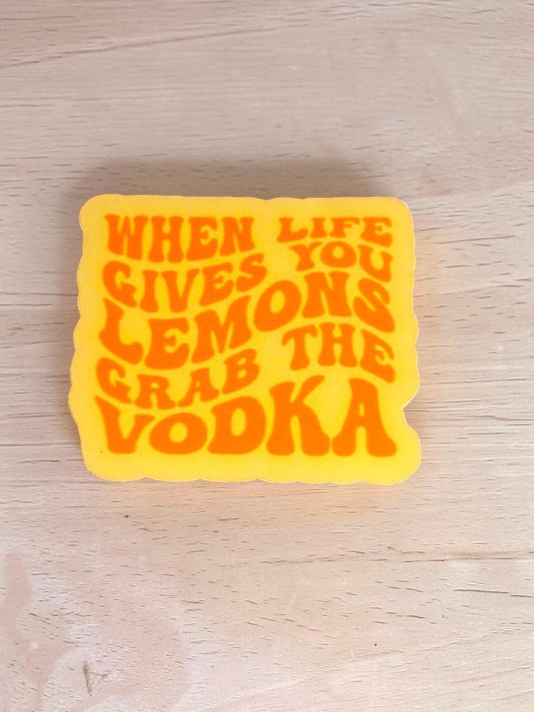 Permanent Sticker with "When Life Gives You Lemons, Grab the Vodka" text on a wooden surface