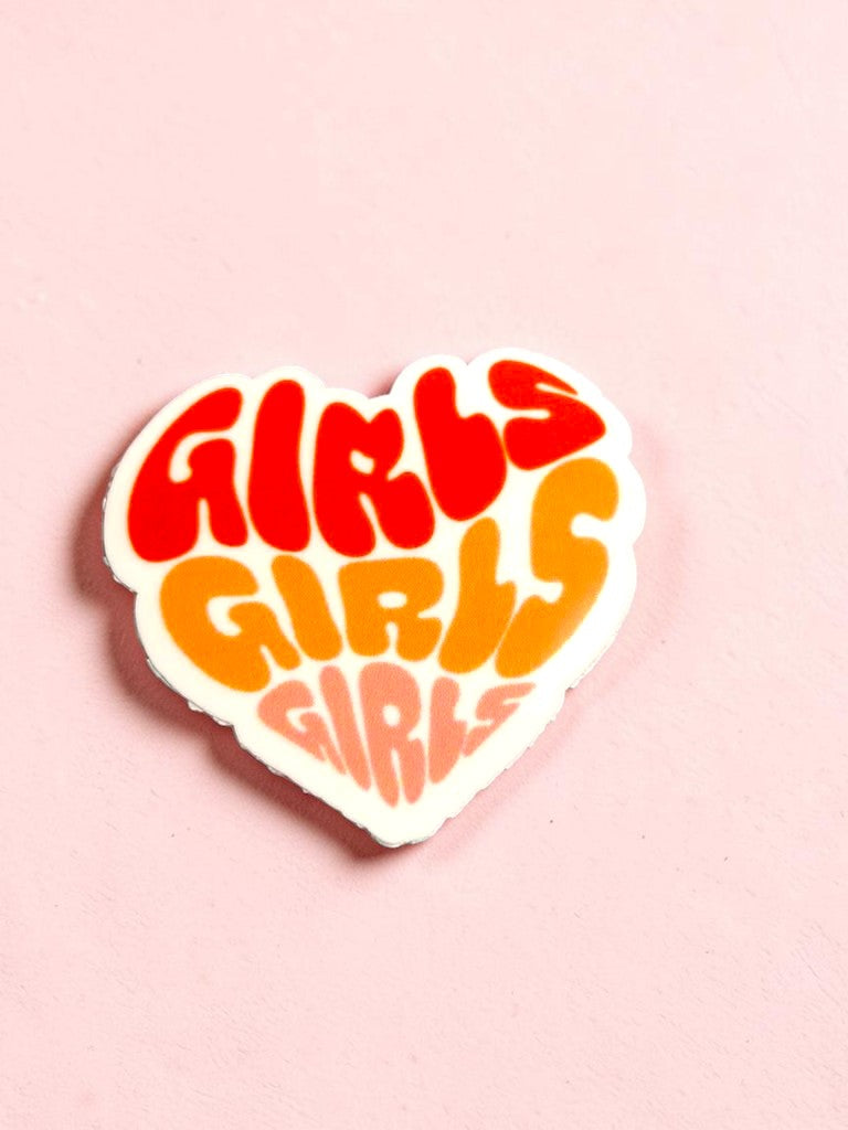 Heart-shaped permanent sticker with 'GIRLS GIRLS GIRLS' text in red, orange, and yellow on a pink background