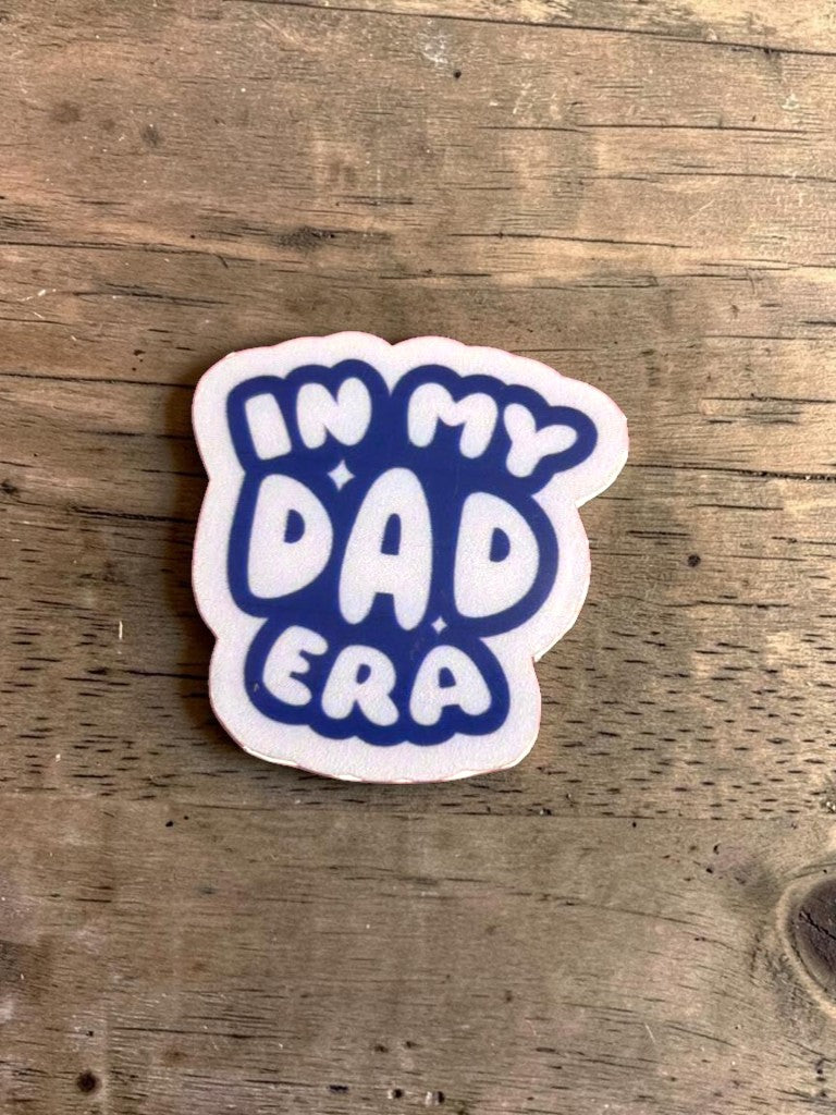 Permanent sticker with 'In my dad era' text on a wooden surface