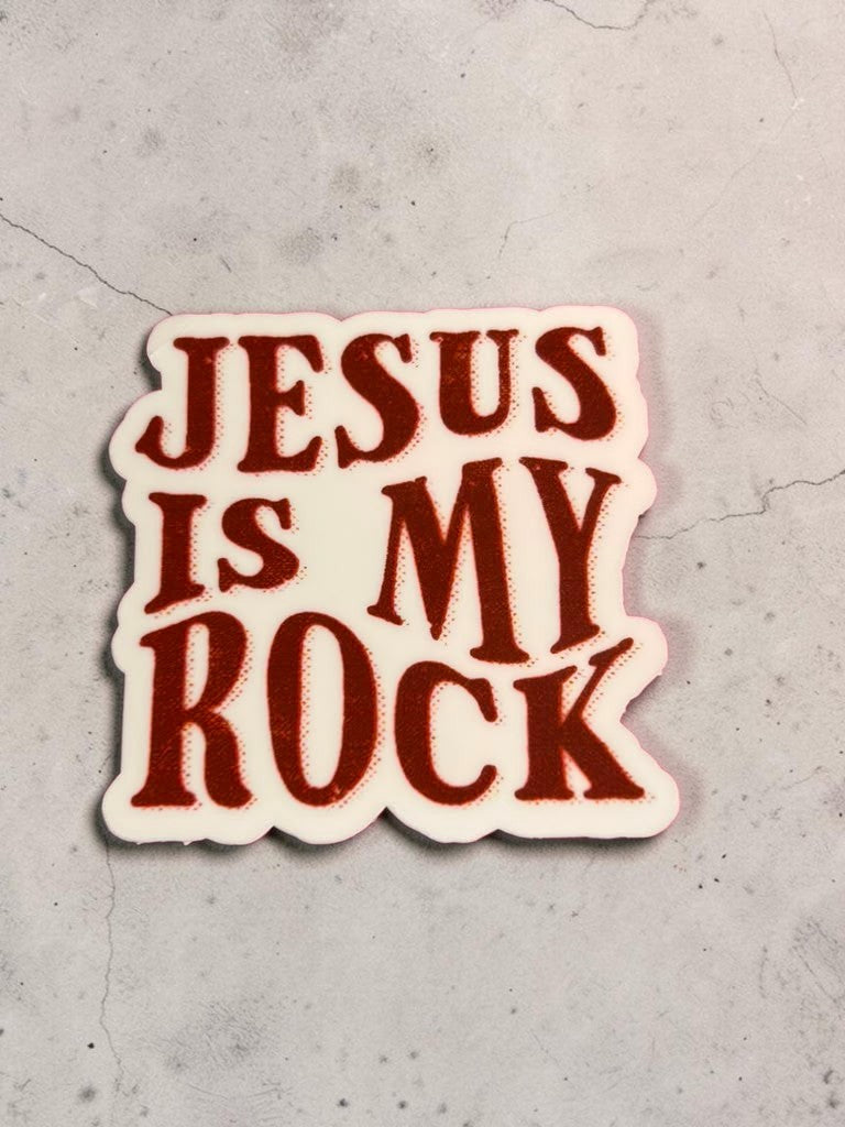 Permanent Sticker with 'Jesus is my rock' text on a concrete surface