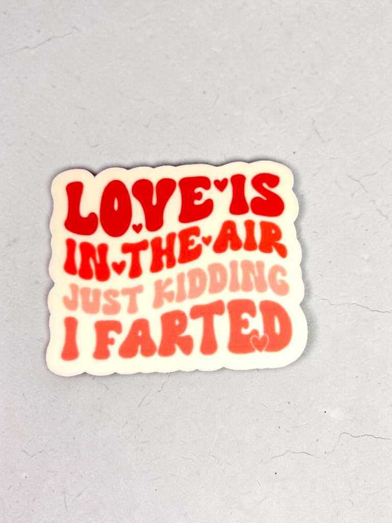 Permanent Sticker with text 'LOVE IS IN THE AIR JUST KIDDING I FARTED' on a gray background