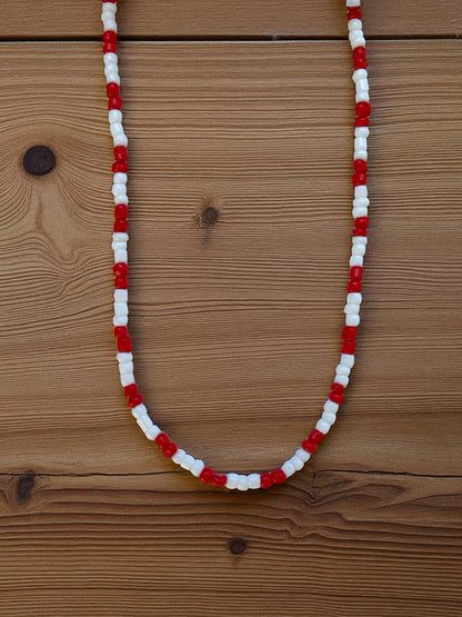 red white simple necklace flat lay minimalist beaded jewelry design