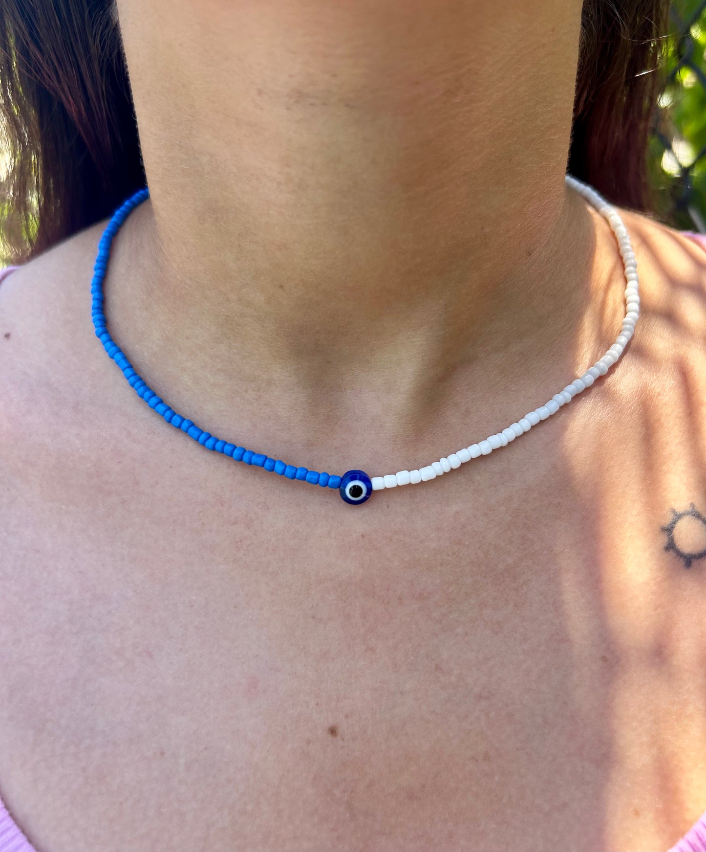 close up blue white eye beads necklace aesthetic jewelry detail design