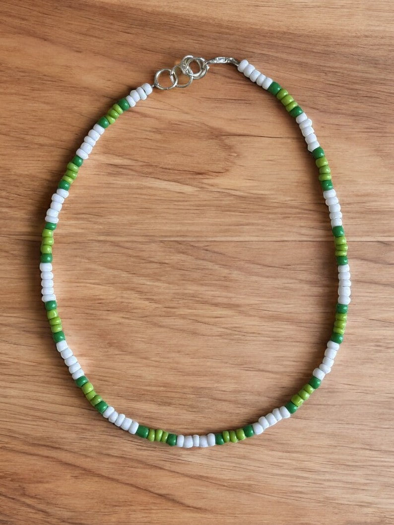 close up green white skinny necklace beaded jewelry detail minimalist design