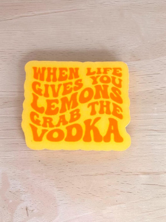 Permanent Sticker with "When Life Gives You Lemons, Grab the Vodka" text on a wooden surface