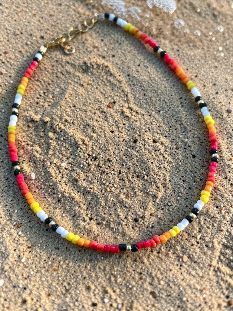 sunset inspired handmade necklace with colorful beads summer fashion jewelry styled on model
