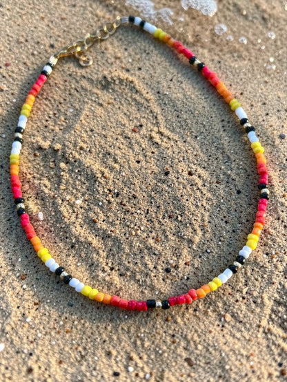 sunset inspired handmade necklace with colorful beads summer fashion jewelry styled on model