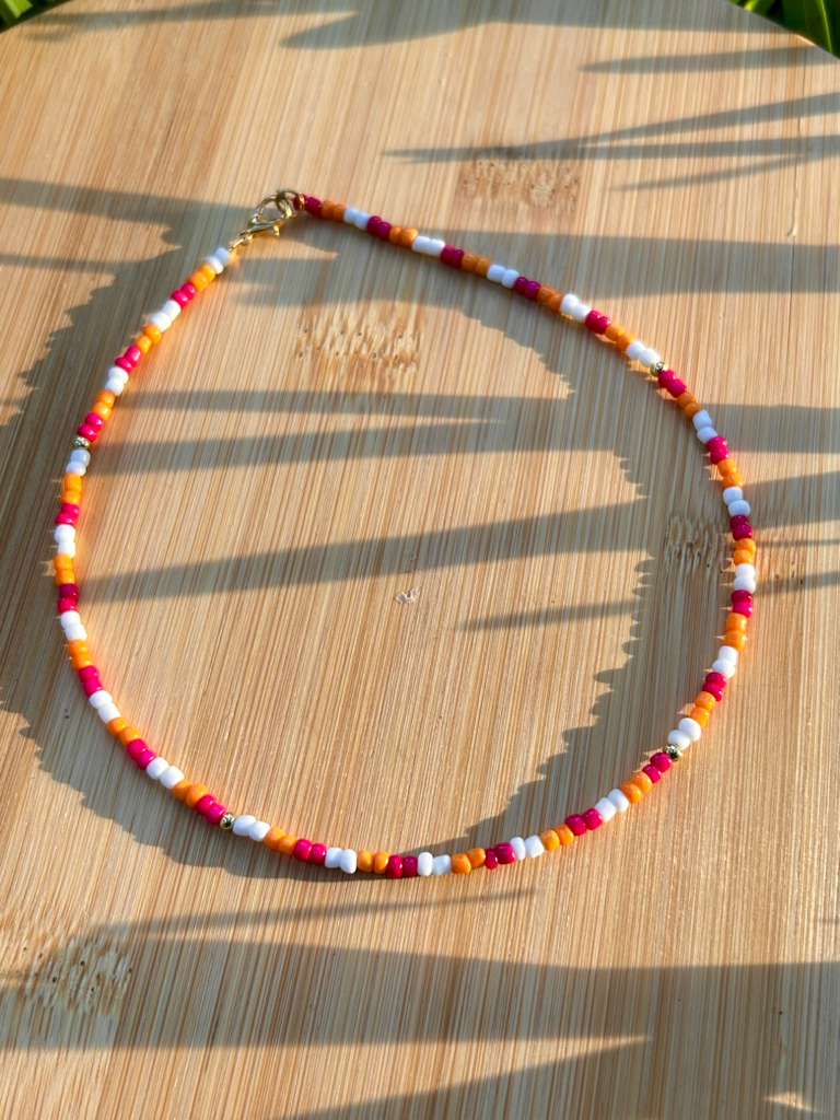 tropical sunset inspired handmade necklace with vibrant beads styled fashion jewelry on model