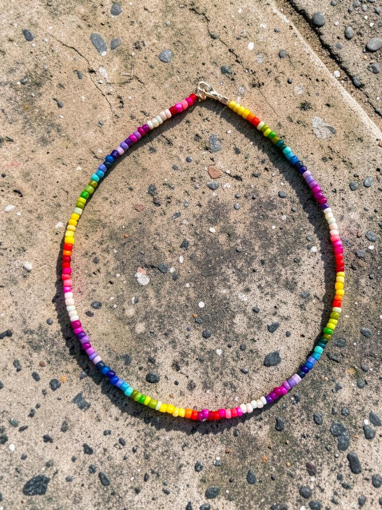 Colorful beaded necklace on a concrete surface