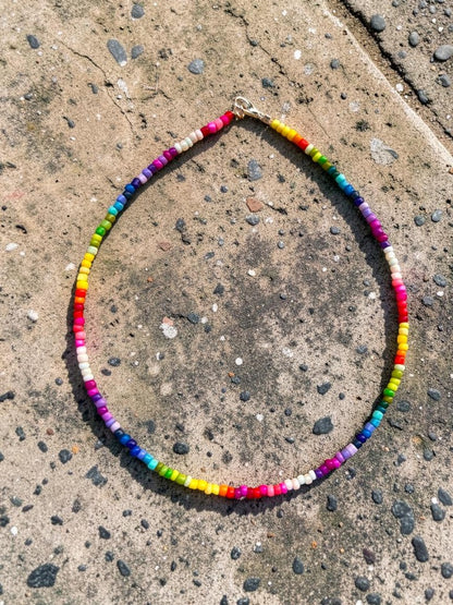 Colorful beaded necklace on a concrete surface